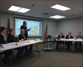  ?? CHAD FELTON — THE NEWS-HERALD ?? Lake County Assistant Prosecutor Michael L. DeLeone, standing, addresses commission­ers from Ashtabula, Geauga and Lake counties last week during a press conference in Painesvill­e regarding the filing of an amicus brief against the federal lawsuit regarding Ohio redistrict­ing. The brief was filed Feb. 6.