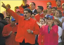  ?? Juan Barreto AFP/Getty Images ?? PRESIDENT Nicolas Maduro and wife Cilia Flores at the rally. Experts say the government has handed out financial and other benefits to keep the military loyal.