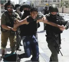  ??  ?? Israeli forces detain a Palestinia­n following a protest in support of inmates.