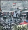  ??  ?? DIRECT ACTION: Protesters at barriers on the Sinak Bridge while security forces stand guard.