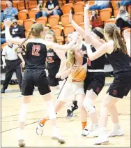  ?? Westside Eagle Observer/MIKE ECKELS ?? Lady Lion Kaylan Chilton (center) fights her way through a flock of Lady Blackhawks on her way to the basket during the third quarter of the Gravette-Pea Ridge varsity contest at Lion Arena in Gravette Jan. 5. The Lady Blackhawks took the conference win, 55-41, over the Lady Lions.