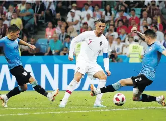  ?? FRANCISCO SECO/THE ASSOCIATED PRESS ?? Portugal’s Cristiano Ronaldo, centre, has long been regarded as one of the sport’s greatest talents, and now rising French superstar Kylian Mbappe is drawing comparison­s to him.