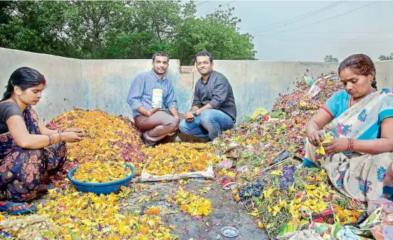  ??  ?? Ankit and Karan pose amidst flowers collected from temples