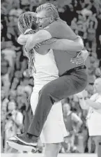  ?? Tom Pennington / Getty Images ?? Brittney Griner, left, and U.S. coach Geno Auriemma celebrated another gold medal with a 101-72 drubbing over Spain.