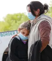  ?? Jerry Lara / Staff photograph­er ?? A migrant mother and child embrace after being detained by Border Patrol agents near La Joya.