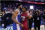  ?? MATT SLOCUM — THE ASSOCIATED PRESS ?? Joel Embiid, left, embraces Miami’s Jimmy Butler after the 76ers exited the playoffs.