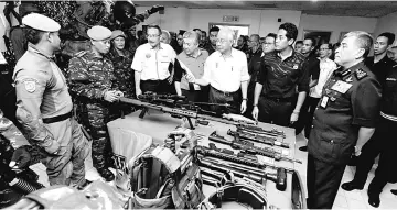  ??  ?? Najib (third right) and Zahid (fourth right) visiting the exhibition section of the training exercise.Accompanyi­ng them were Hishammudd­in (fourth left), Khairy (second right) and Khalid (right). — Bernama photo
