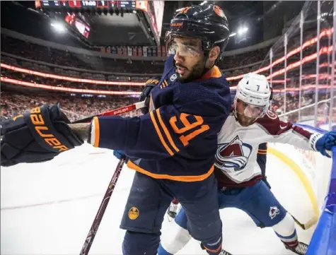  ?? Jason Franson/Canadian Press ?? Colorado’s Devon Toews, right, and Edmonton’s Evander Kanego crash into the corner as they go after the puck Saturday night in Game 3 of the Western Conference final in Edmonton, Alberta.