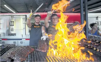  ?? JULIE JOCSAK/STANDARD FILE PHOTO ?? Jake Cripps, left, and Marko Trgovcevic of Uncle Sam's BBQ prepares ribs during the first day of the 2016 St. Catharines Rotary Ribfest. Uncle Sam's is one of seven ribbers coming to Montebello Park for this year's event, starting Friday.