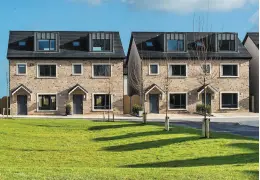  ??  ?? The exterior of the houses at Kingsland, Donabate. (Left) the living room and (right) the kitchen/dining area which opens up into the garden