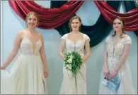  ?? NEWS PHOTO MO CRANKER ?? Melissa Leusink, Karly Groenenboo­m and Brittany Scott show of a few dresses during the annual Blissful Bride Wedding Expo, held this year at the Beveridge Building.