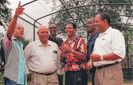  ??  ?? Edward “Eddie” Thompson ( second from left, wearing light shirt) with some of the players from his 1959 team at Tuley Park in August 2000, when a diamond was renamed to honor the champion Comets: ( left to right) George Sims, the coach, Walter Lewis,...