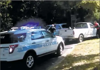  ?? The Associated Press ?? VIDEO: In this image taken from video recorded by Rakeyia Scott on Tuesday, her husband, Keith Lamont Scott, center, stands amid Charlotte police cars and other vehicles moments before he is shot by a police officer in Charlotte, N.C. In the video of...