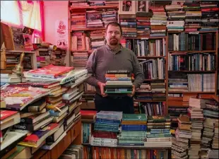  ??  ?? Wally O’Neill packing up orders at Red Books in St Peter’s Square.