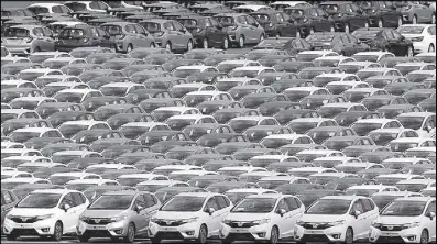  ??  ?? Newly manufactur­ed cars of the automobile maker Honda await export at port in Yokohama, south of Tokyo.