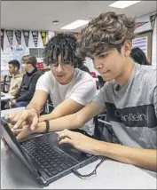  ?? Photograph­s by Mel Melcon Los Angeles Times ?? WILLIAM Lopez Rodas, left, and Daniel Safa go over an assignment during the computer science class.