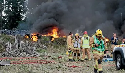  ?? PHOTO: EMMA DANGERFIEL­D/STUFF ?? Firefighte­rs work to contain a tyre fire in North Canterbury.