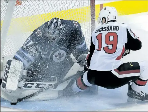  ?? KEVIN KING/WINNIPEG SUN ?? Jets’ Connor Hellebuyck makes a stop on Senators’ Derick Brassard. Ken Wiebe thinks Brassard would fit in well with the Jets.