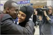  ?? RICK BOWMER — THE ASSOCIATED PRESS ?? Abdisellam Hassen Ahmed, a Somali refugee who had been stuck in limbo after President Donald Trump temporaril­y banned refugee entries, kisses his wife Nimo Hashi, after arriving at Salt Lake Internatio­nal Airport, Friday in Salt Lake City. Ahmed meet...