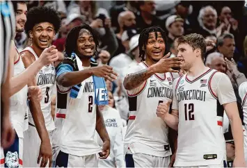  ?? Michael Dwyer/Associated Press ?? UConn players celebrate shortly before the end of Thursday’s Sweet 16 win over San Diego State in Boston.