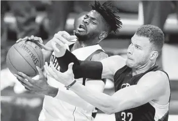  ?? Tom Fox Dallas Morning News ?? NERLENS NOEL, left, of the Mavericks wants a rebound that Blake Griffin also covets during the Clippers’ loss at Dallas. The Clippers next will play Utah, one place ahead of them in the West standings.