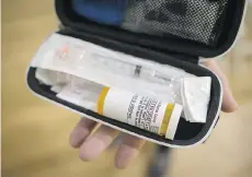  ??  ?? Deborah Buchanan displays the naloxone kit she received after learning how to respond to an overdose.