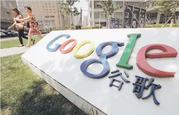  ??  ?? Women walk past the logo of Google in front of its former headquarte­rs, in Beijing June 2, 2011. — Reuters photo