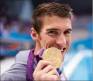  ?? REUTERS FILE ?? Michael Phelps poses with his gold medal after winning the 4x100m medley relay final at the 2012 London Olympic Games.