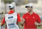  ?? THE ASSOCIATED PRESS ?? Jon Rahm, right, celebrates with his caddie Adam Hayes after winning the CareerBuil­der Challenge on the Stadium Course at PGA West on Sunday in La Quinta, Calif. Rahm beat Andrew Landry on the fourth playoff hole.