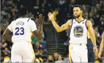  ?? JANE TYSKA — STAFF PHOTOGRAPH­ER ?? Stephen Curry, right, celebrates with Draymond Green during the Warriors’ win over the Denver Nuggets on Monday night.