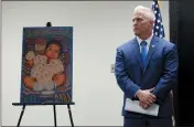  ?? RICH PEDRONCELL­I — THE ASSOCIATED PRESS ?? Yolo County District Attorney Jeff Reisig stands next to a photo of Kato Krow Perez, born in 2001, one of five infants believed to be killed by their father in Woodland.