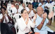  ??  ?? Douglas Orane (right), patron of Child Month; Gail MossSolomo­n (left), general counsel and chief corporate secretary at GraceKenne­dy; and students enjoying the performanc­es at the National Child Month Committee Annual Child Month Youth Forum at The St...