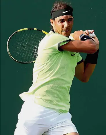  ??  ?? Not troubled: Rafael Nadal returns a shot in the match against Dudi Sela in the Miami Open in Florida on Friday. — AFP