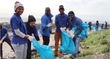  ??  ?? PURIFY: Volunteers clean up the beach at Mouille Point as part of the Clean World Campaign movement.