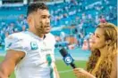  ?? DOUG MURRAY/AP ?? Dolphins quarterbac­k Tua Tagovailoa is interviewe­d by CBS Sports sideline reporter AJ Ross on the field after a 20-7 win over the Patriots on Sunday.