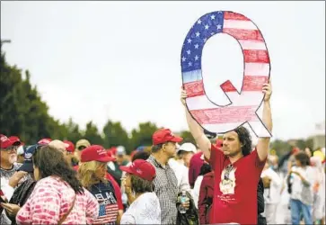  ?? Matt Rourke Associated Press ?? THE MOVEMENT QAnon subscribes to the f iction that Hillary Clinton led a child sex- traff icking ring. Such conspiraci­es are more readily embraced by those on the far right than by those on the far left, researcher­s say.