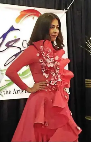  ?? KEVIN MARTIN — THE MORNING JOURNAL ?? A model showcases one of Nelli Millard’s original designs from her “Morning Glory” collection at the Lorain Arts Council’s 7th Annual Fashion Show Fundraiser at Black River Landing on March 25.