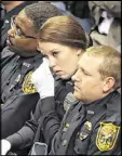  ?? CURTIS COMPTON / CCOMPTON@AJC.COM ?? A Montezuma police officer wipes her eyes during the funeral of Jody Smith on Wednesday.