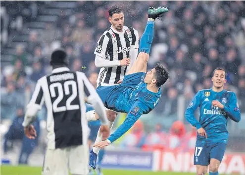  ??  ?? Real Madrid’s Cristiano Ronaldo scores with a stunning bicycle kick against Juventus in the Champions League at Allianz Stadium.