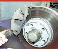  ??  ?? 19 UNDO BRAKE CALIPERS Clean the brakes thoroughly before you dismantle them. Use a wire brush over the exterior of the caliper assembly to remove rust and dust. A bit of proprietar­y brake cleaner spray won’t go amiss. Take care when cleaning because of the delicate brake sensor wire on the offside front wheel.