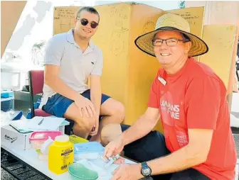  ?? Photo / Supplied ?? Whanganui District Health Board immunisati­on coordinato­r Bruce Jones (right) gave Barnaby Smith a measles jab at the Whanganui River Markets.