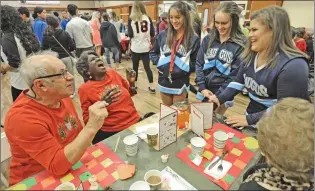  ?? Signal file photo ?? Seniors Rudy Pavini, left and Tommie Ward chat with Saugus High School students from left, Amanda Arce, Veronica Johnson and Lauren Henderson at the Santa Clarita Valley Senior Center during the 35th Thanksgivi­ng feast hosted by the Castaic Lions Club,...