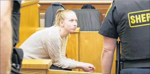  ?? TARA BRADBURY ?? Anne Norris waits for the courtroom to be cleared in order to speak with her lawyers, Rosellen Sullivan and Jerome Kennedy, Thursday in Newfoundla­nd and Labrador Supreme Court in St. John’s on Day 4 of her first-degree murder trial.