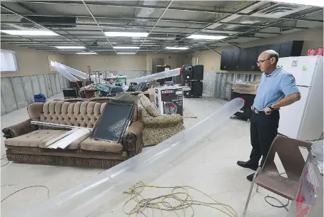  ?? DAN JANISSE ?? Dan Soulliere, executive director of Brentwood Recovery Home, looks over the basement of the women’s residence on Tuesday. The building suffered extensive damage during the recent flood. “Some areas of the women’s building had three feet of water at...