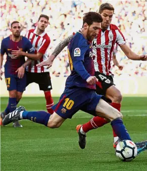  ??  ?? Unstoppabl­e: Barcelona’s Lionel Messi (centre) lining up a shot in the La Liga match against Athletic Bilbao at the Nou Camp on Sunday. — Reuters