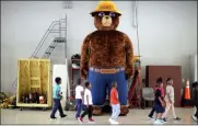  ?? JANET S. CARTER — DAILY FREE PRESS VIA AP ?? A giant Smokey Bear statue greets children at the Fire Department Open House at Fire Station One in Kinston, N.C. The icon of the longest-running public service campaign in the U.S., was born when the U.S. Forest Service and the Ad Council agreed a fictional bear would be the symbol for a fire prevention campaign.