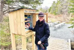  ?? ROSIE MULLALEY • THE TELEGRAM ?? Elizabeth Kearley, a director with the Chamberlai­ns Park Action Committee, stops to tidy the books in the park’s Free Little Library.