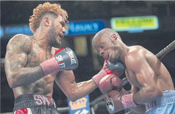  ??  ?? Jarrett Hurd, left, punches Tony Harrison during their fight in February.