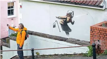  ??  ?? Bless you: Banksy’s ‘Atchoo’ mural on a Bristol house — which appeared last month — raised its value from £300,000 to an estimated £5 million