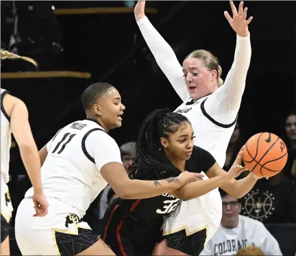  ?? CLIFF GRASSMICK — STAFF PHOTOGRAPH­ER ?? Colorado players Quay Miller, left and Charlotte Whittaker pressure Stanford guard Jzaniya Harriel during their game Jan. 14in Boulder.
